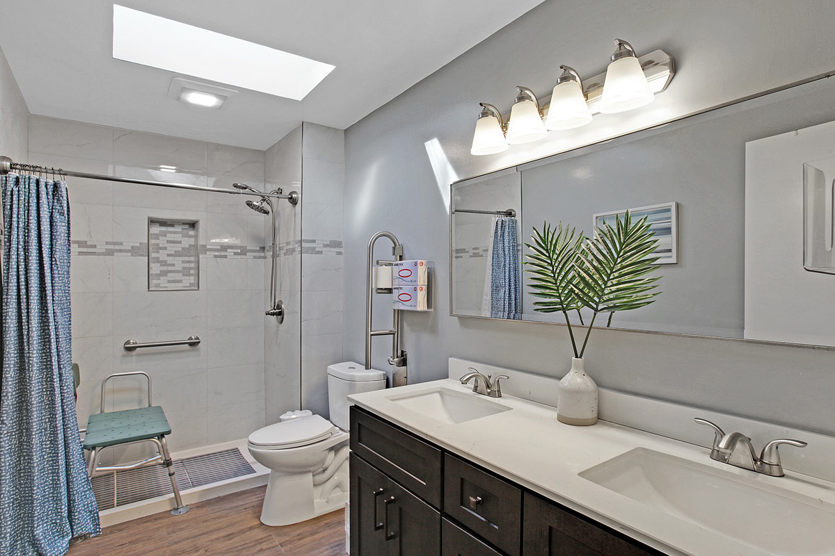 An accessible bathroom with grab bars and a shower seat