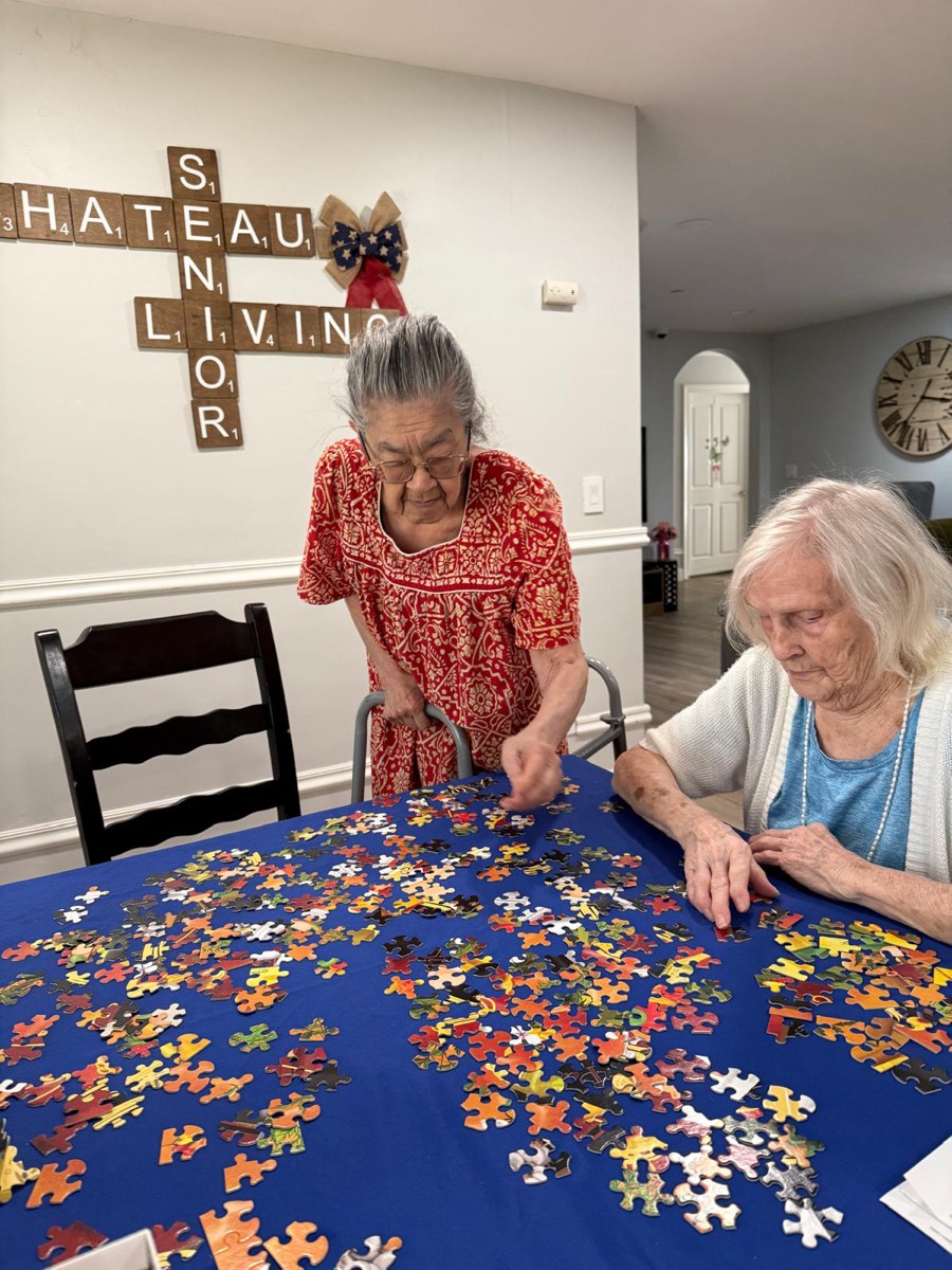 Residents working on a jigsaw puzzle at The Gardens