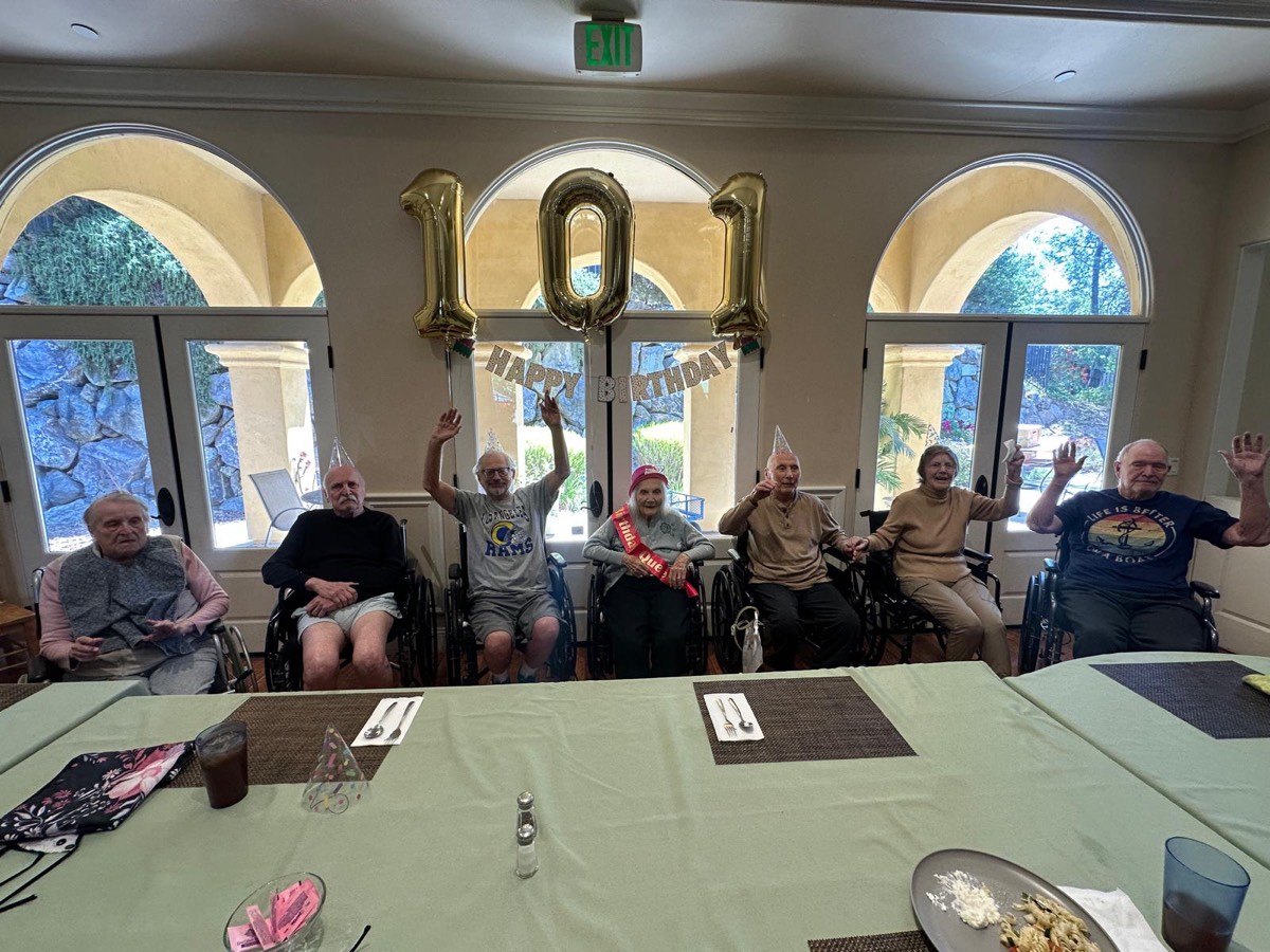 Residents waving at a 101st birthday celebration