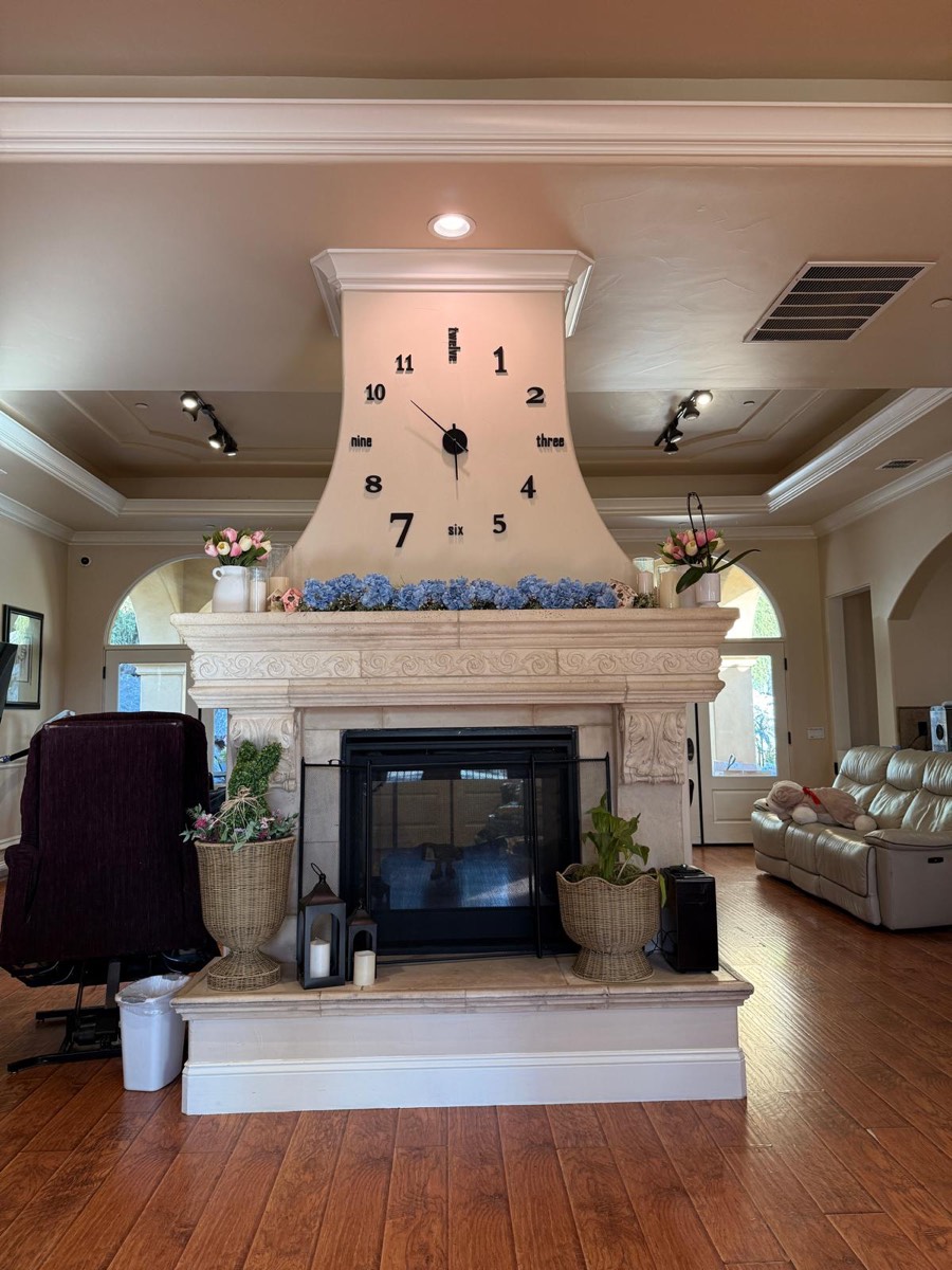 The living room, with its fireplace and wall clock